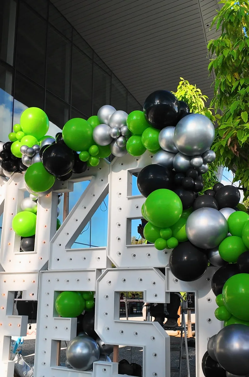 Dense balloon clusters cascading over the top row of 2026 marquee numbers at NVIDIA in Santa Clara