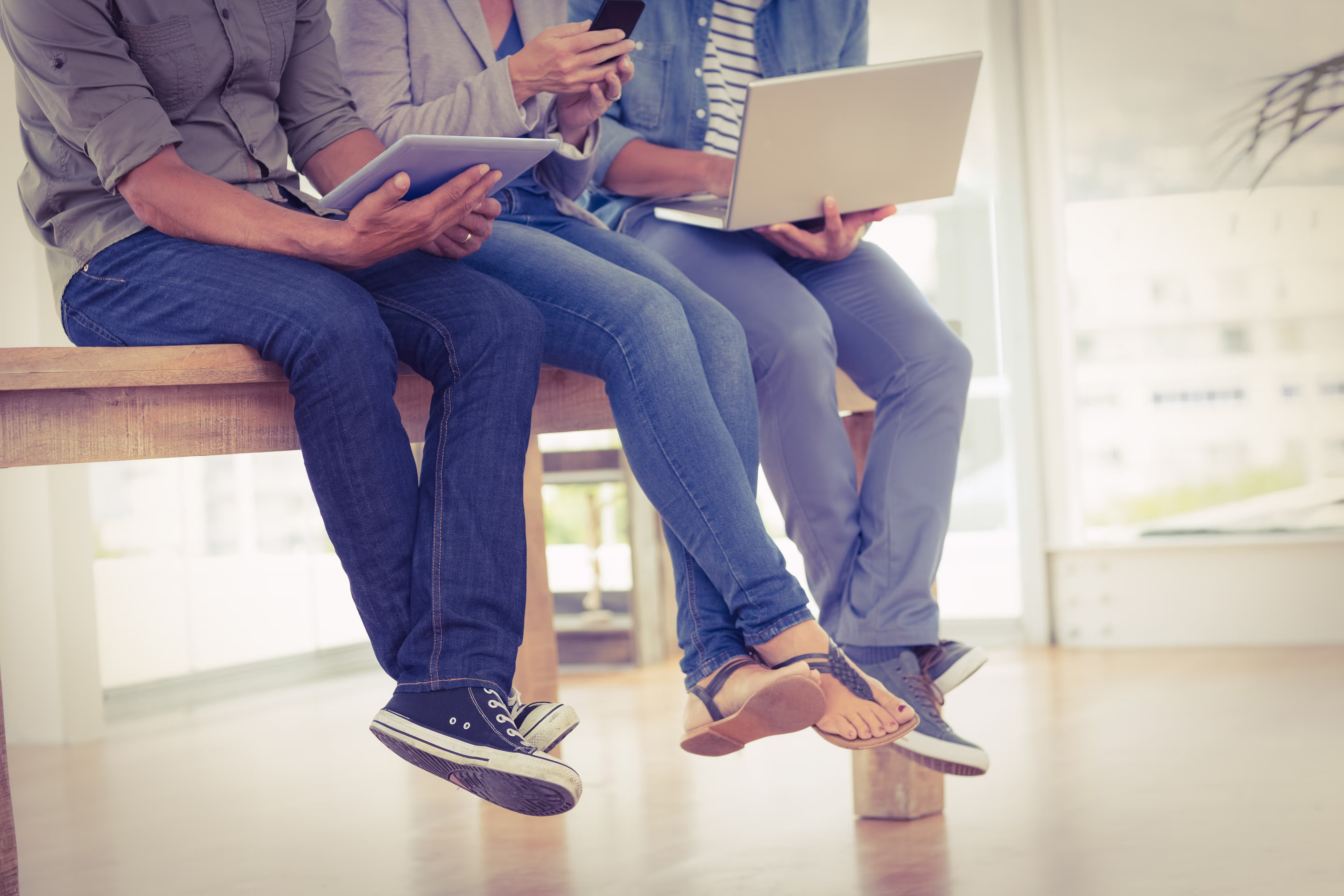 Brightter team members sitting together and working on their laptops