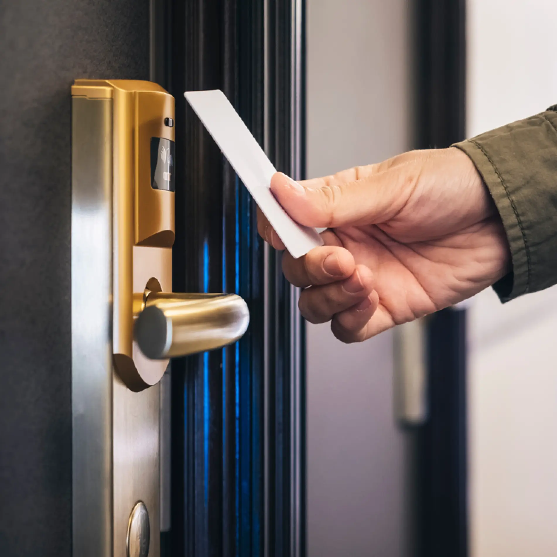 Person scanning a hotel keycard to enter a hotel room