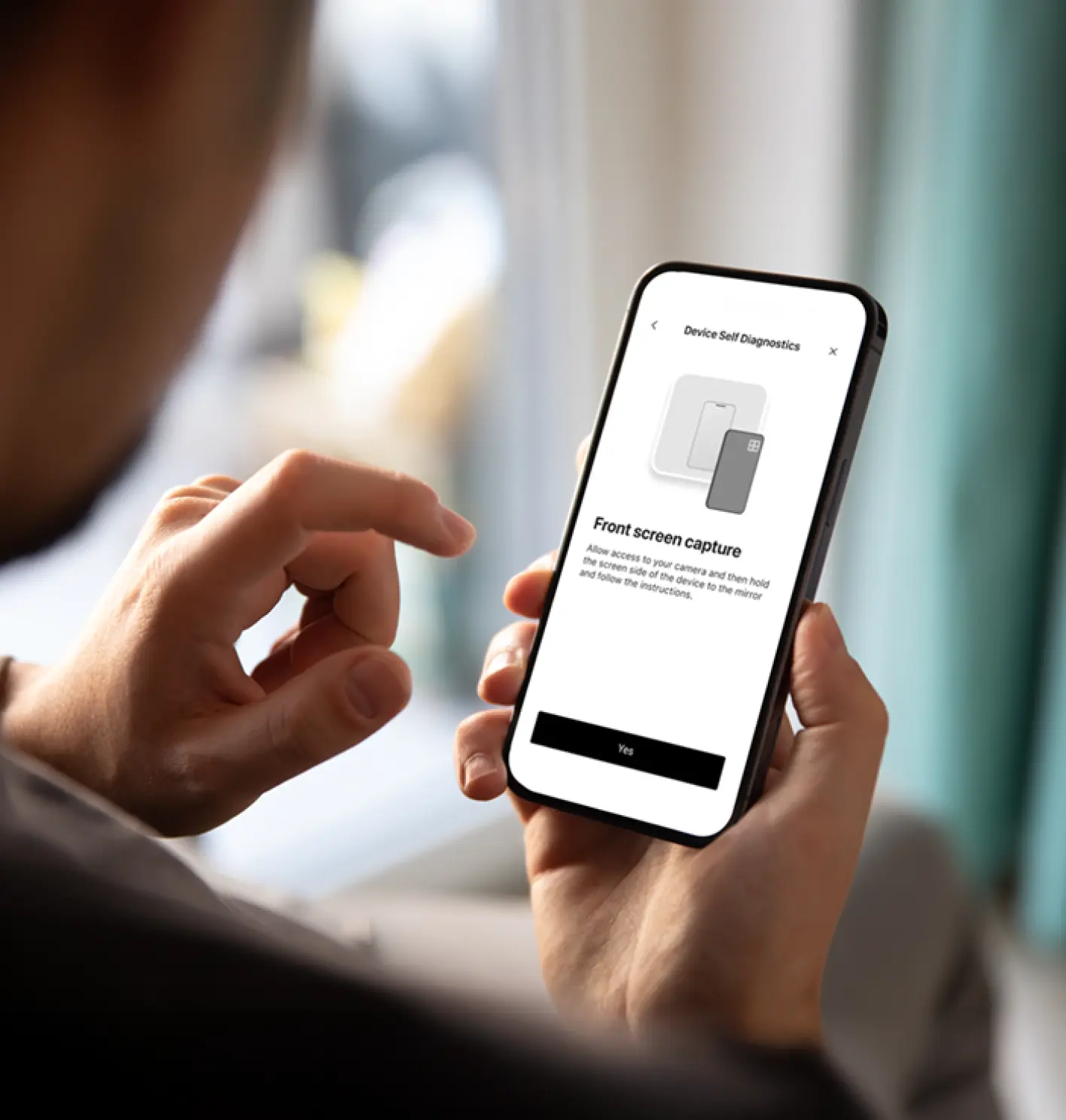 Person holding a smartphone displaying a 'Front screen capture' prompt in a device self diagnostics app.