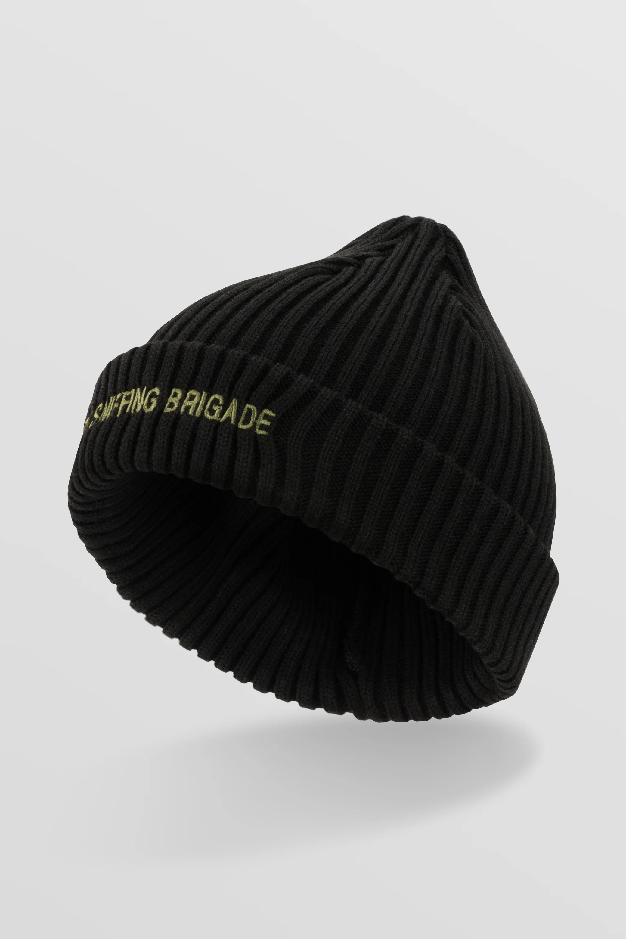 A structured rib-knit beanie in black with a cuffed silhouette and khaki green embroidery. “69th Sniffing Brigade” on the front, “ISSL × NAFO” on the back. One size.
