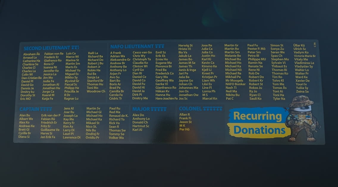  Black NAFO Truck, displaying a large list of the names of the recurring donors names of ranks of recurring donors of the 69th Sniffing Brigade Second Lieutenant, NAFO Lieutenant Captain, Major and Colonel