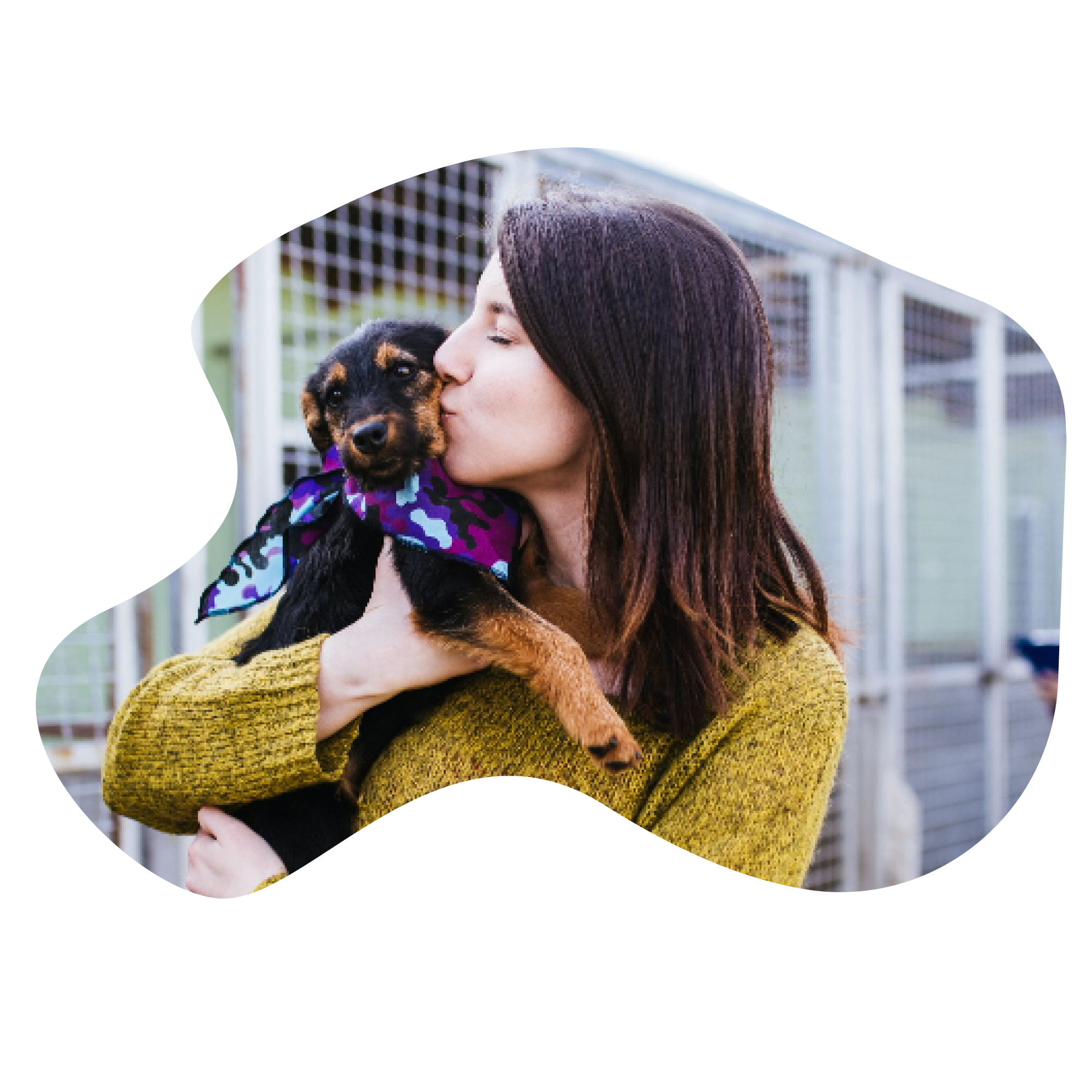 woman kissing puppy.