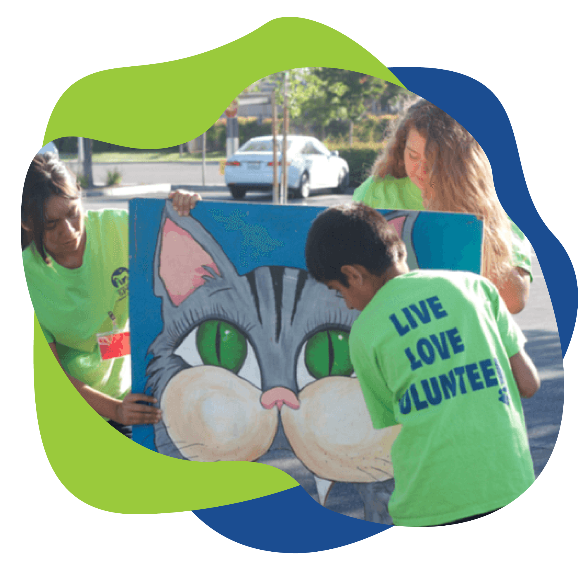 volunteers holding up cat painting.
