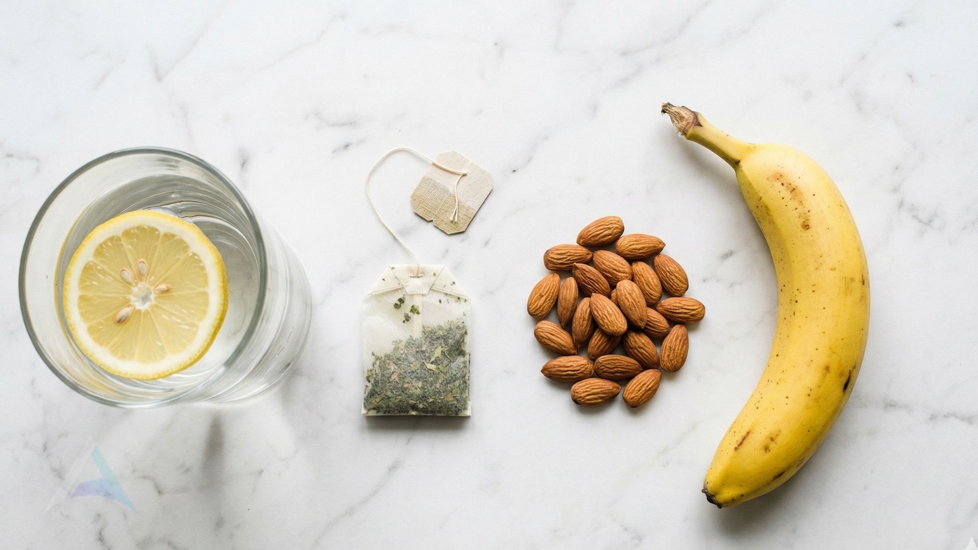 Natural energy alternatives including water with lemon, green tea, almonds, and banana representing nervous system-friendly options to coffee for those with migraines or vertigo