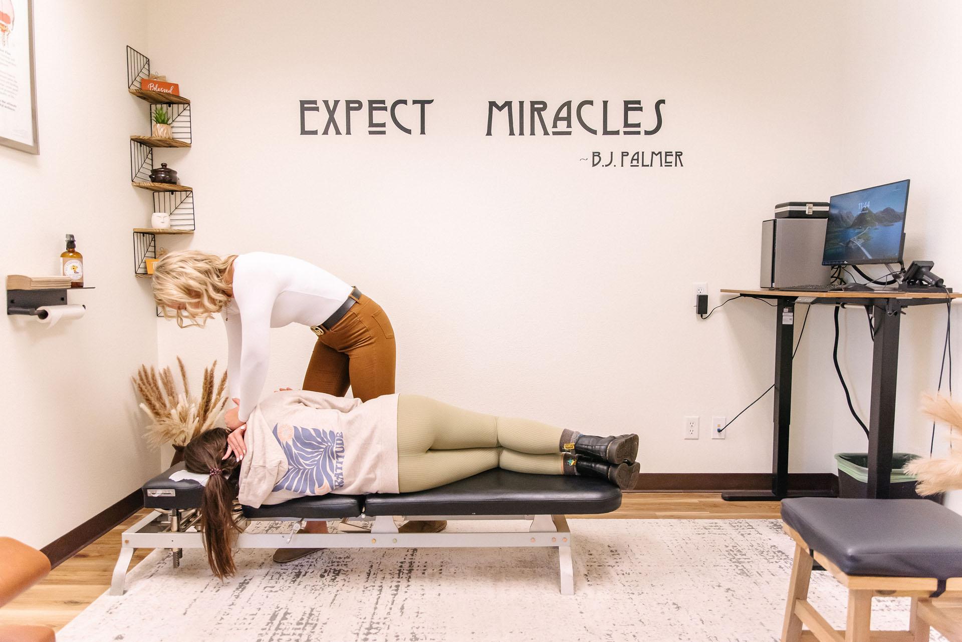 Close-up of a chiropractor's hands performing an adjustment