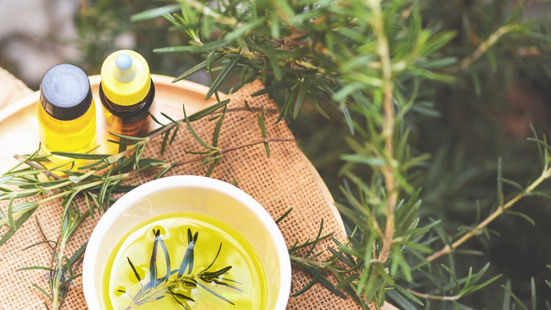 Person holding fresh herbs near their nose representing the recovery of taste and smell through nervous system support and upper cervical chiropractic care after COVID