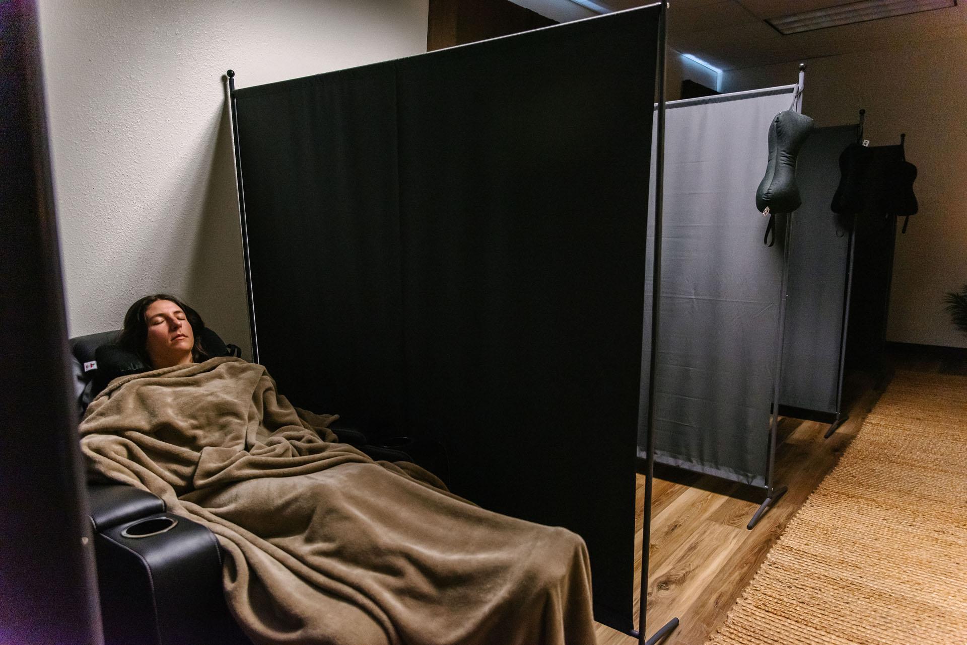 Patient sitting relaxed in a chiropractic treatment chair representing the calm and comfortable first visit experience at Peak Upper Cervical Center
