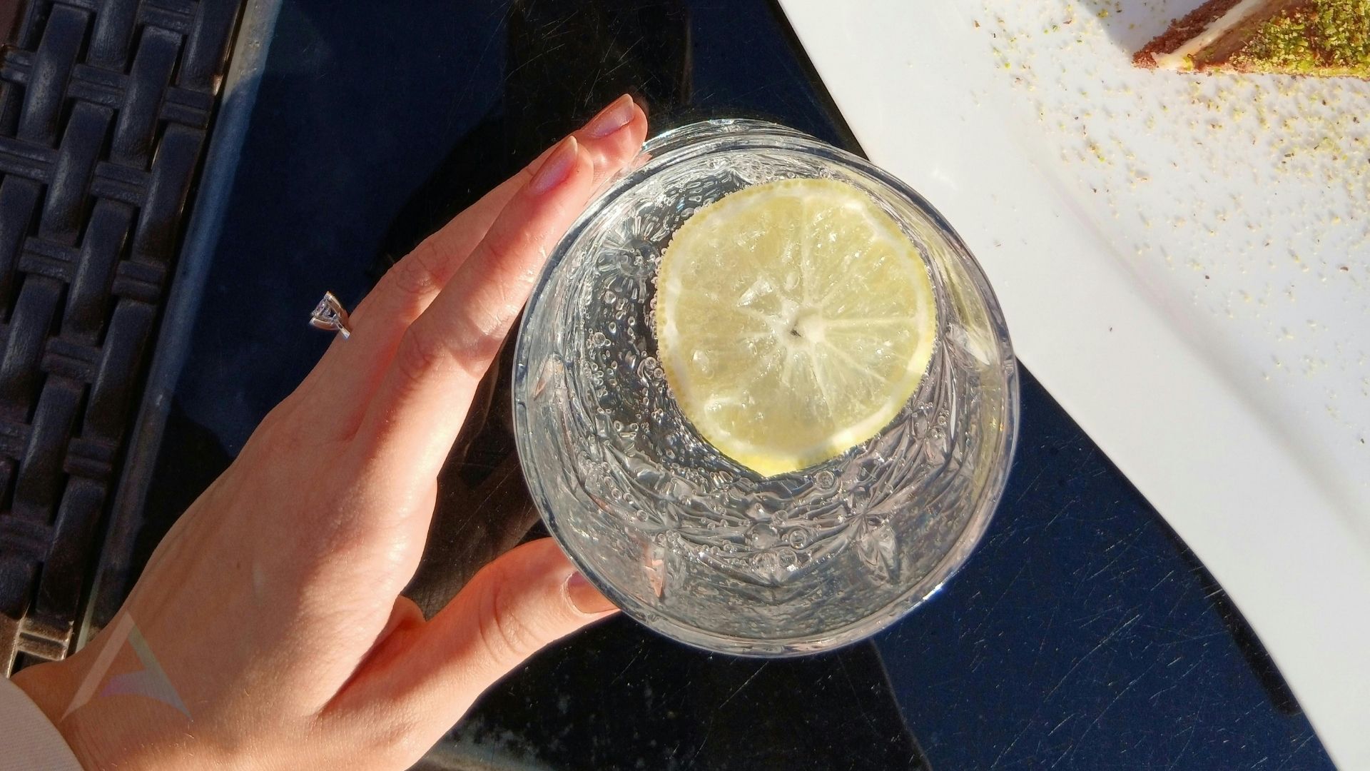 Flat lay of hydrating foods and electrolyte drops including cucumber, watermelon, orange, water with mint, and mineral drops representing practical daily hydration strategies for nervous system health