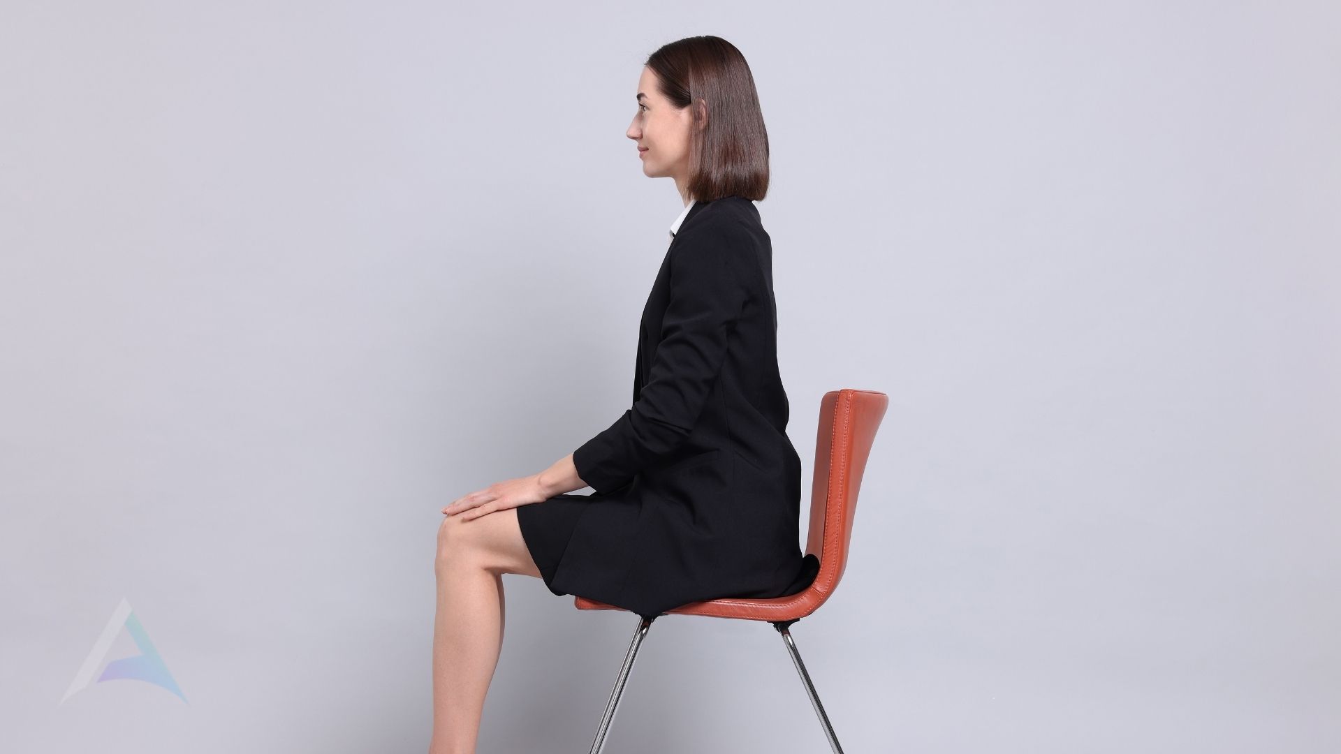 Person sitting with neutral head and neck alignment at a desk representing proper posture habits that reduce TMJ strain and upper cervical spine tension