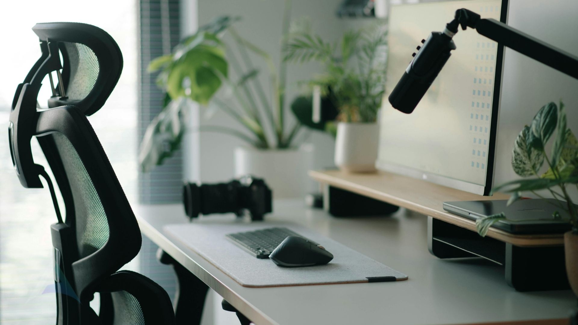 Ergonomic home-office setup with a monitor at eye level, representing good posture to help prevent neck-related headaches