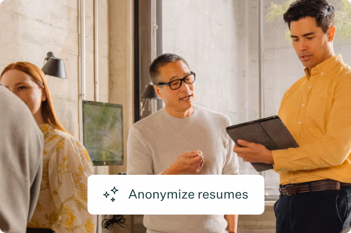 Two office workers discussing content on a tablet