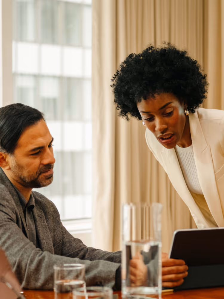 Image of man and woman looking at tablet