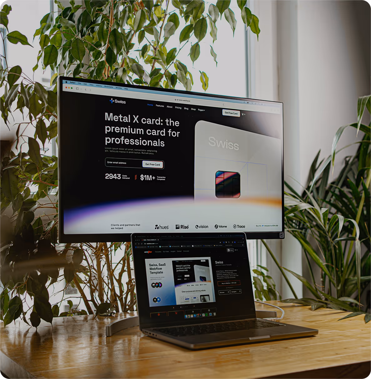 Laptop and desktop monitor displaying a modern website