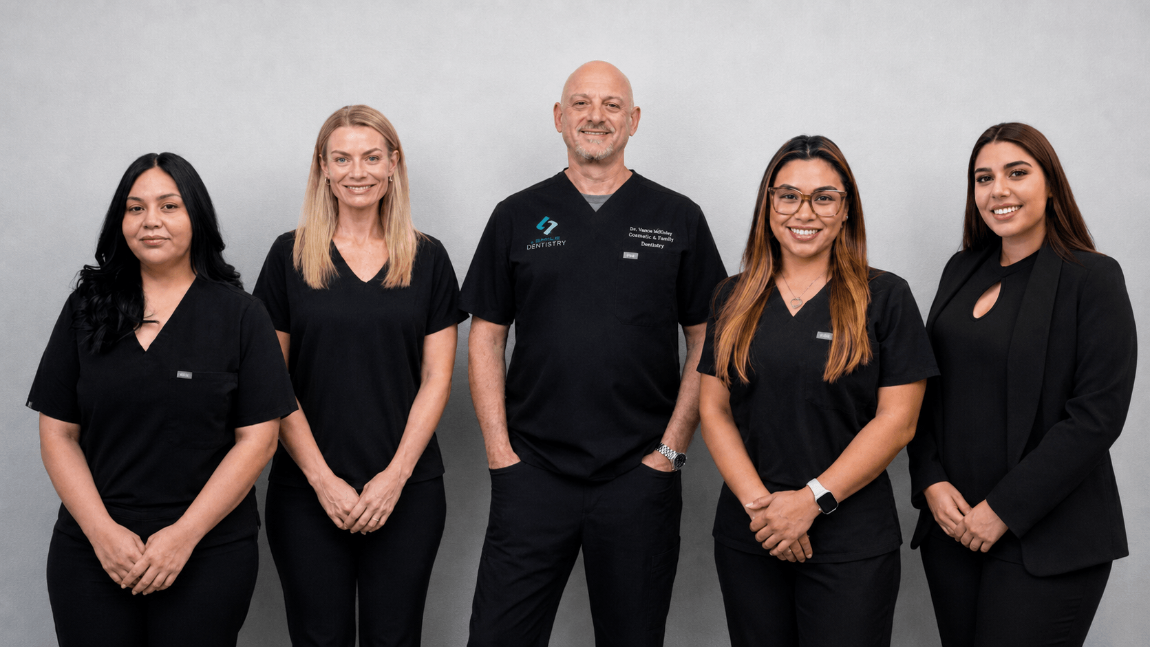 Clairemont Dentistry team photo in San Diego, CA featuring the dentist and staff in black scrubs, showcasing the friendly, professional team behind the practice’s cosmetic and family dental care.