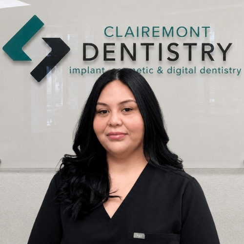 Clairemont Dentistry team member with long black hair wearing black scrubs
