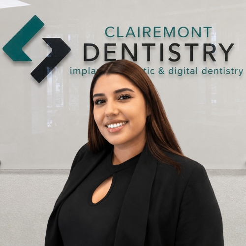 Clairemont Dentistry team member with long dark brown hair wearing a black blazer