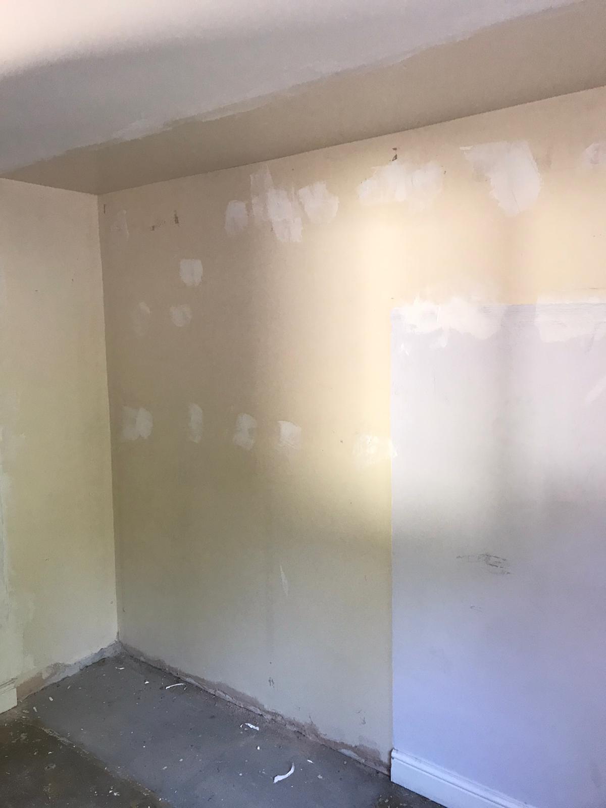 Wall being prepped ready for painting.