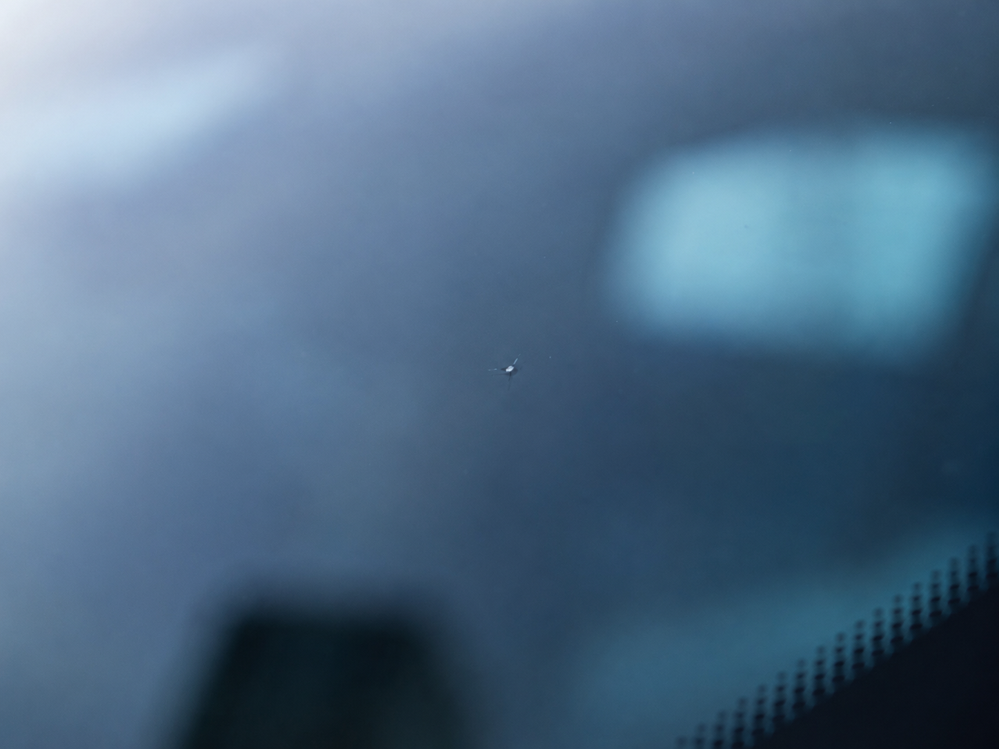 Tiny rock chip in a car windshield with no long cracks