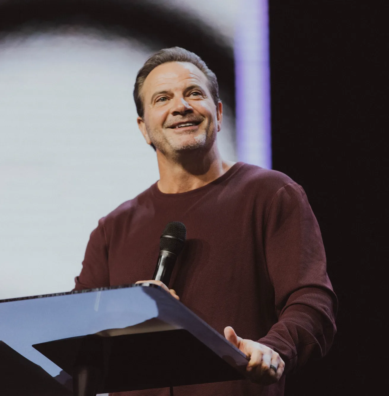 Pastor Marcus Mecum on stage during a sermon