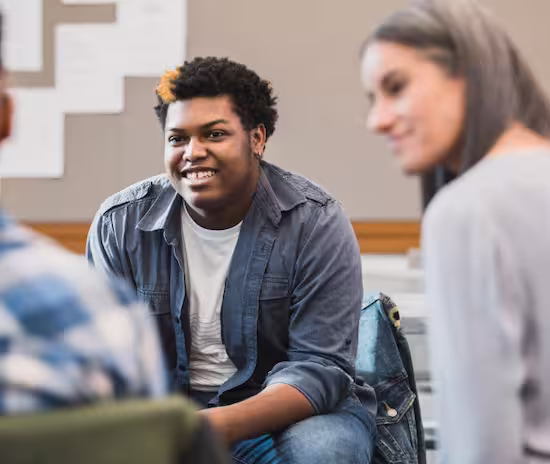 a group of young people sitting around each other during group therapy
