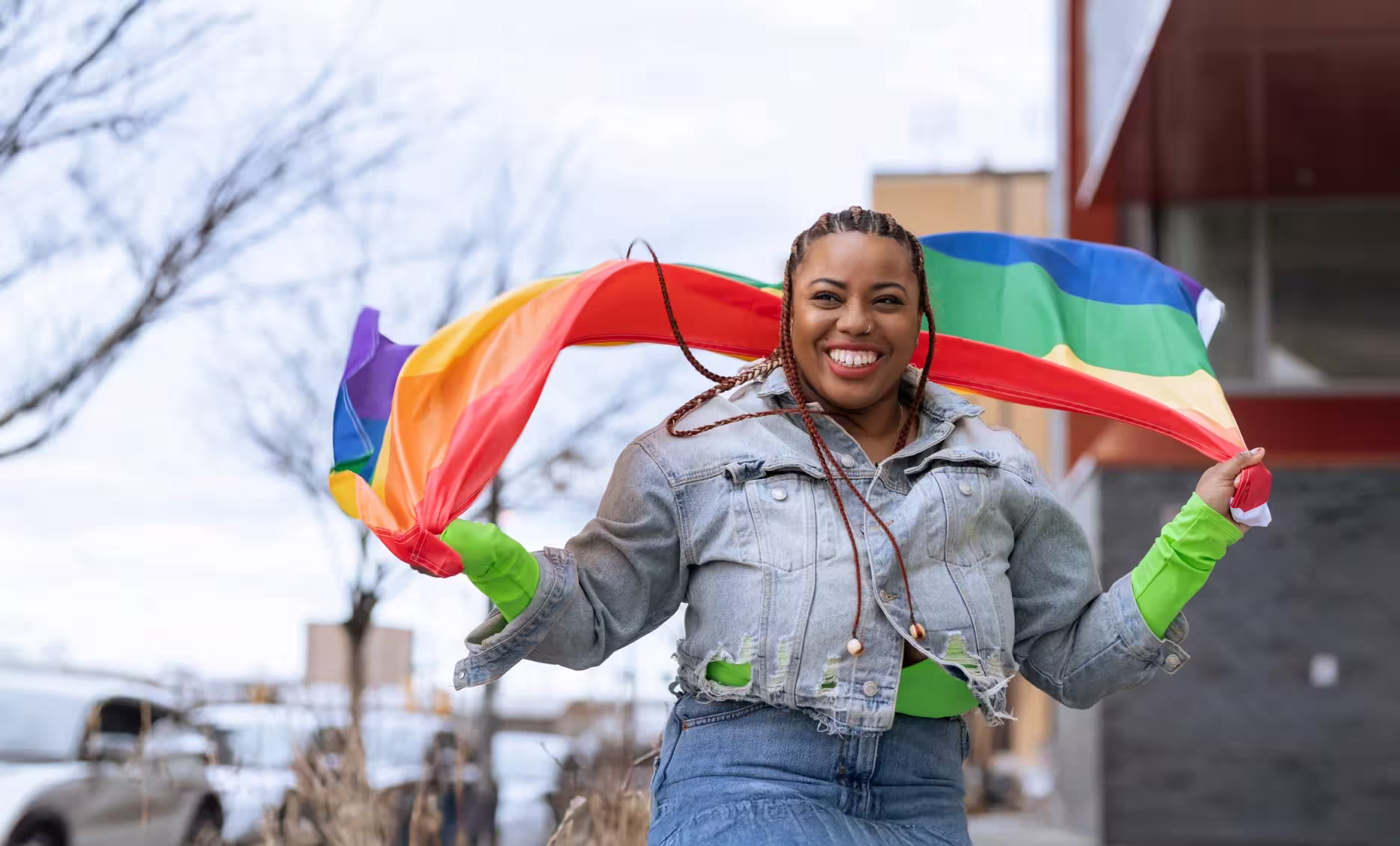 a person holding a rainbow colored fabric