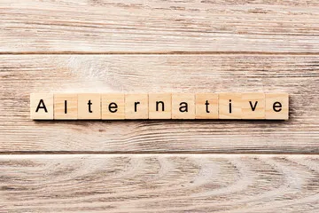 alternative word written on wood block. alternative text on table, concept