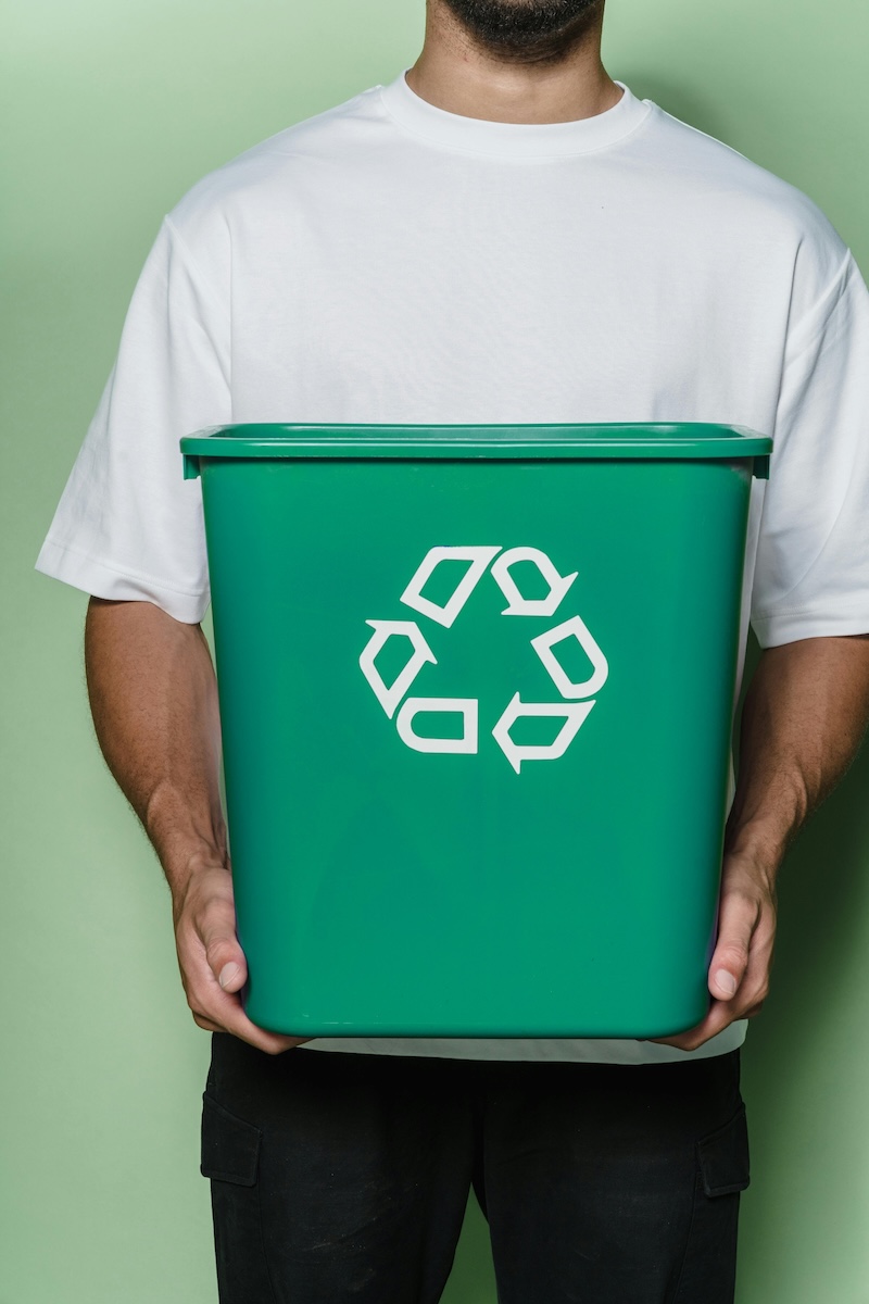 Man holding a recycling bin