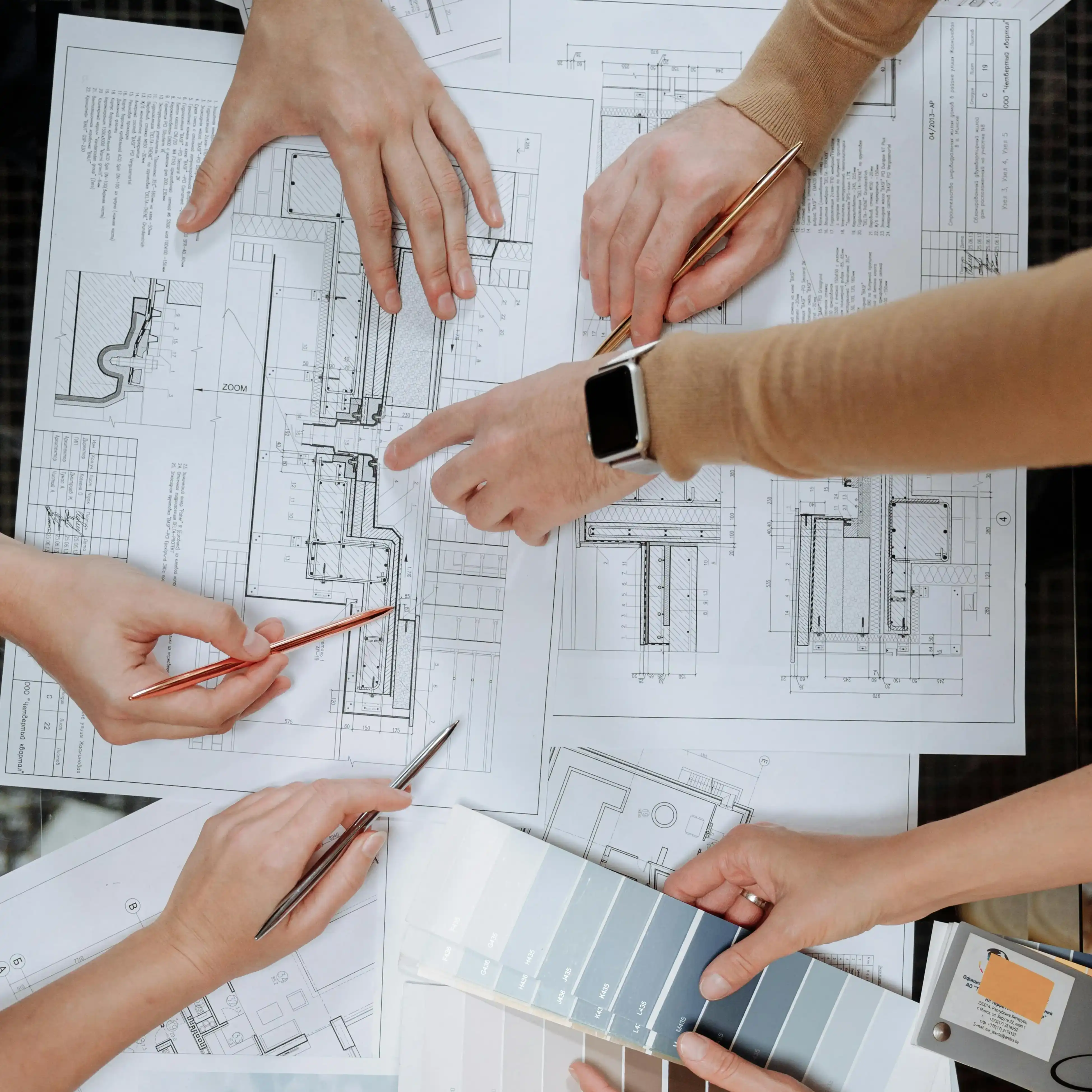 Multiple people consulting plans
