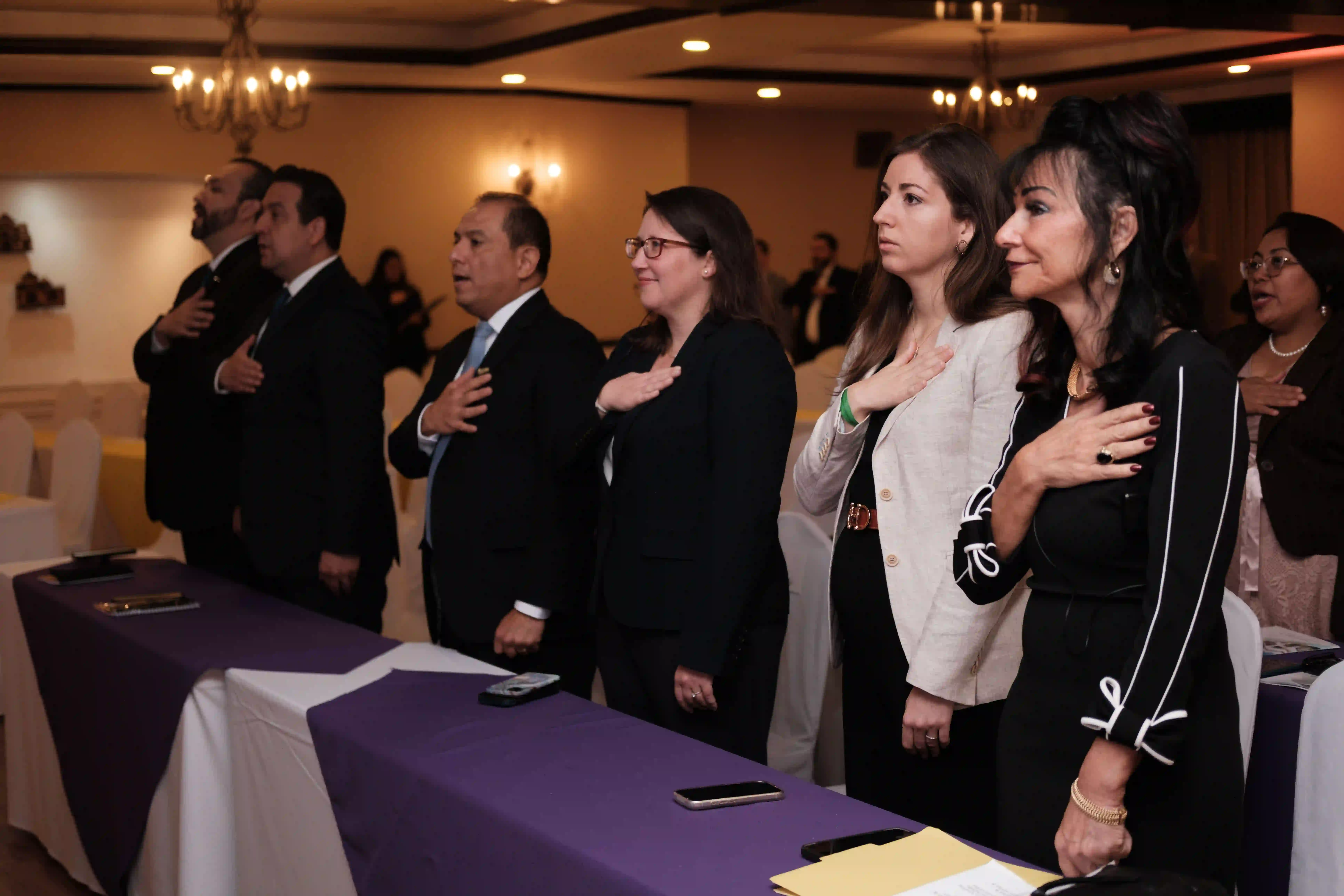 Representatives from the Guatemalan justice system and Kids Alive cross their hands over their heart to salute the dedication for a new future for Guatemala's justice system.