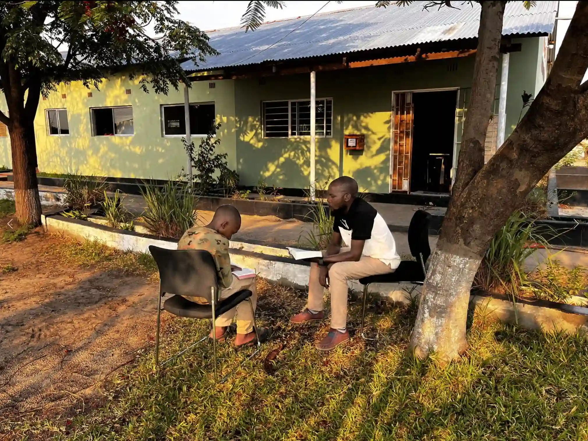 Edwin sitting with his counselor at Lilato Children's Care & Justice Center receiving discipleship.