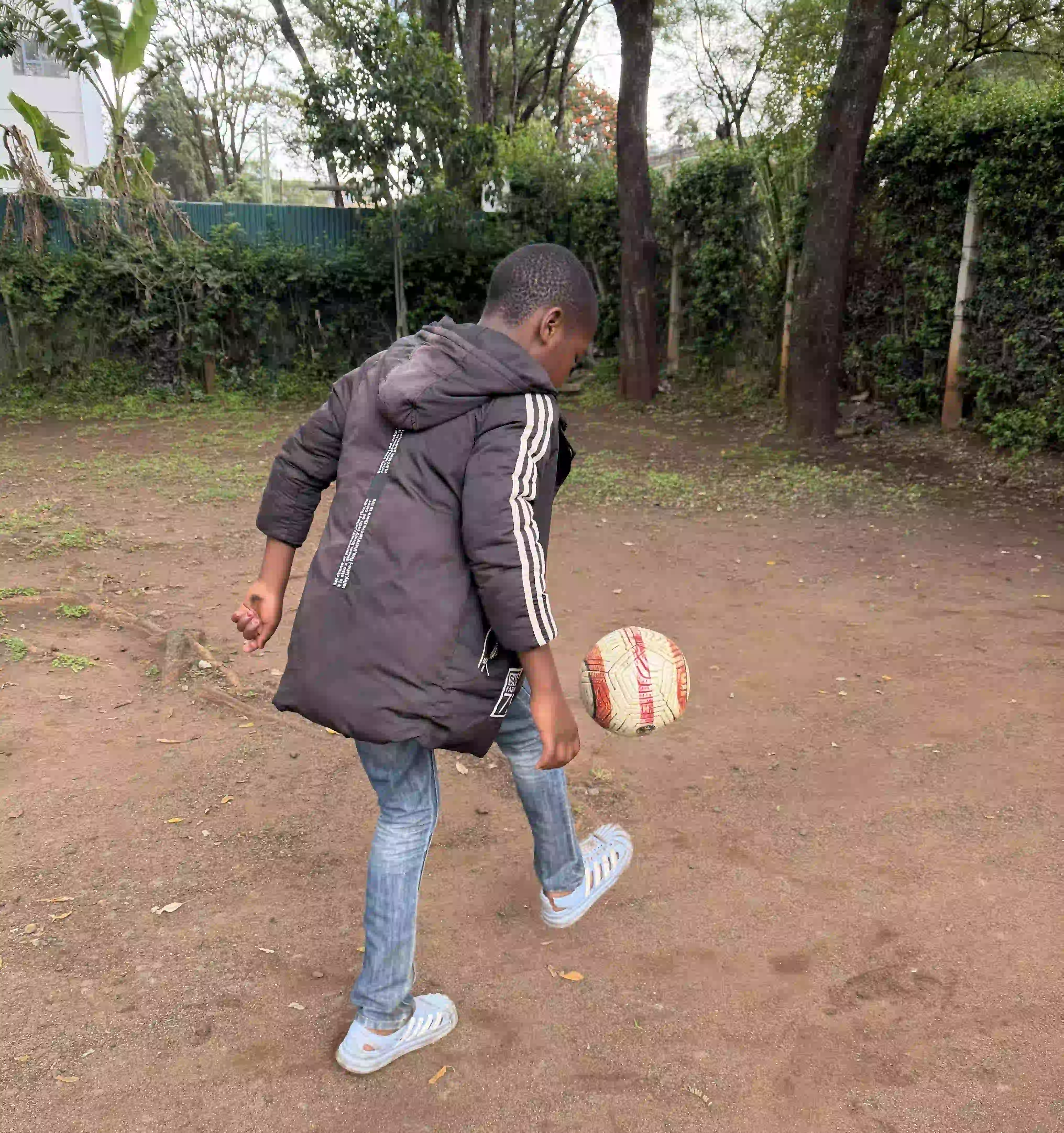 Ayaan practicing soccer, hoping to become a professional player when he grows up.