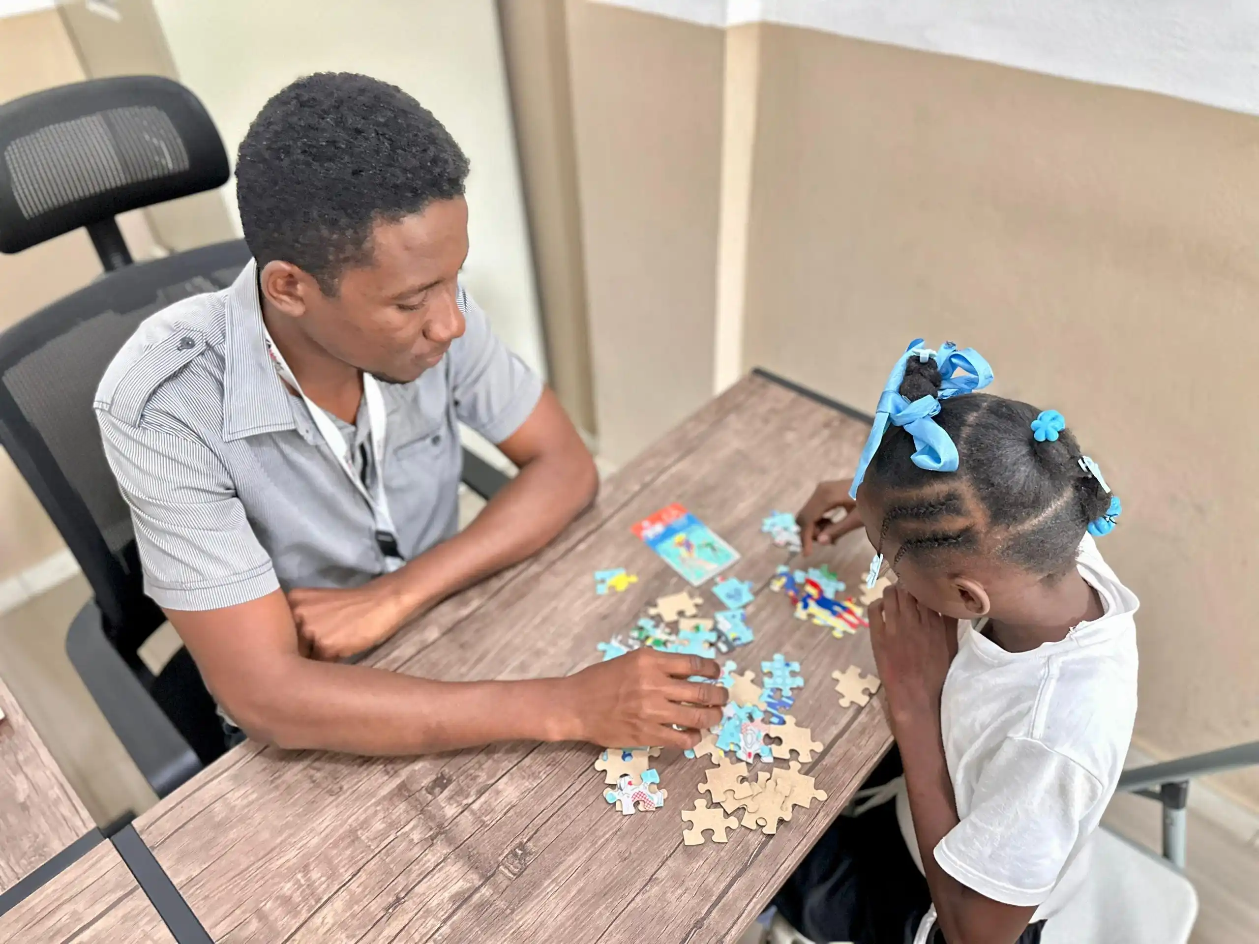 Reseline receiving a therapy session at Kids Alive Haiti school.