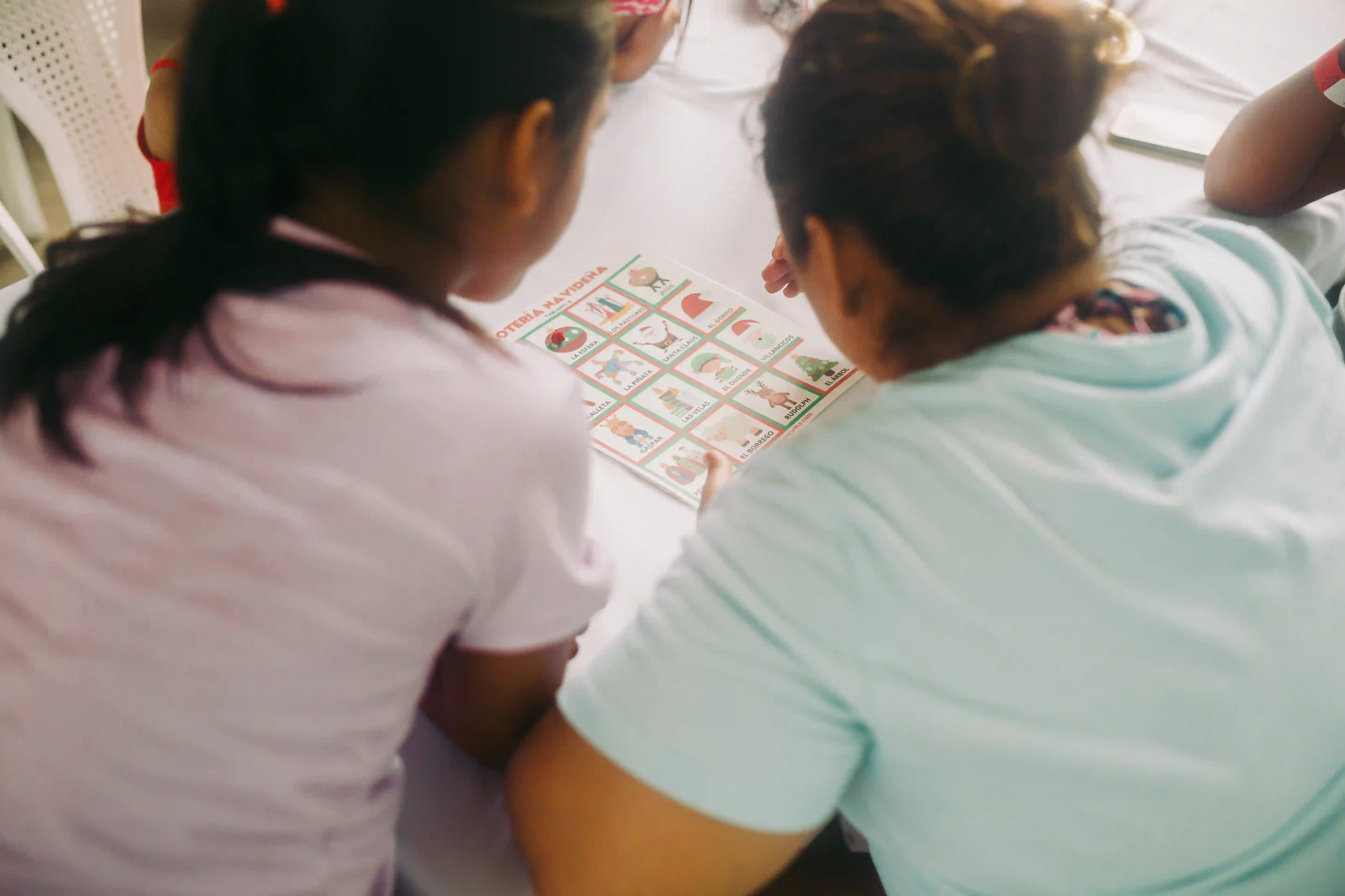 A mother and daughter working on an activity together.