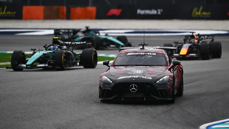 The Mercedes-AMG safety car leads a line of Formula 1 cars around the Sepang circuit