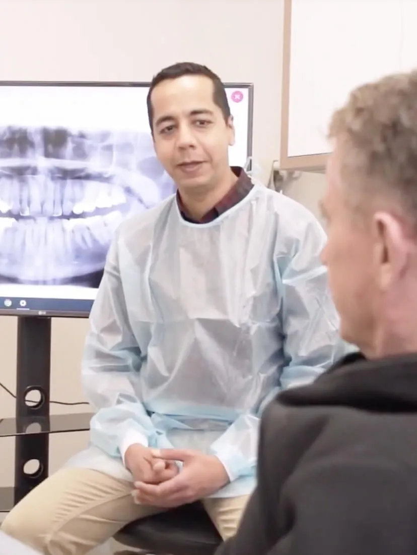Myrtleford dentist Dr Amit in Australia discussing dental treatment with a patient using advanced dental technology.