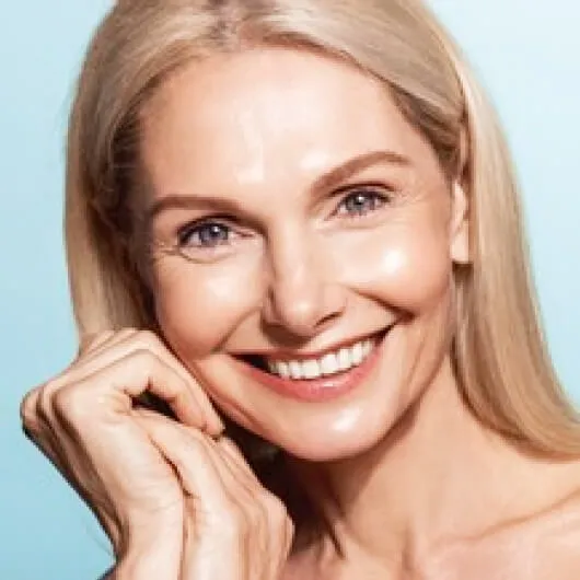 Smiling female patient after All-on-4 dental implants at a Myrtleford dental clinic in Australia.