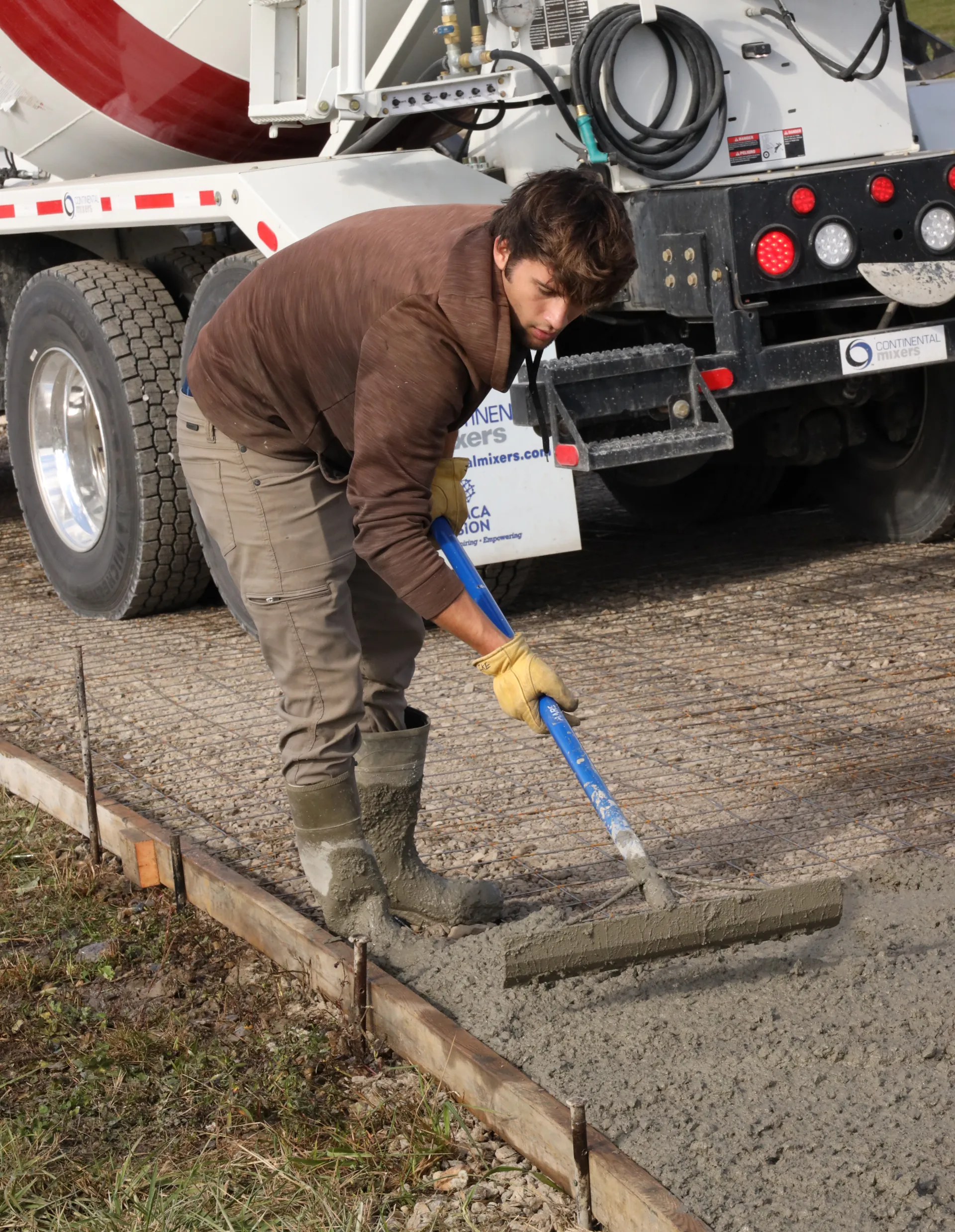 man leveling fresh concrete