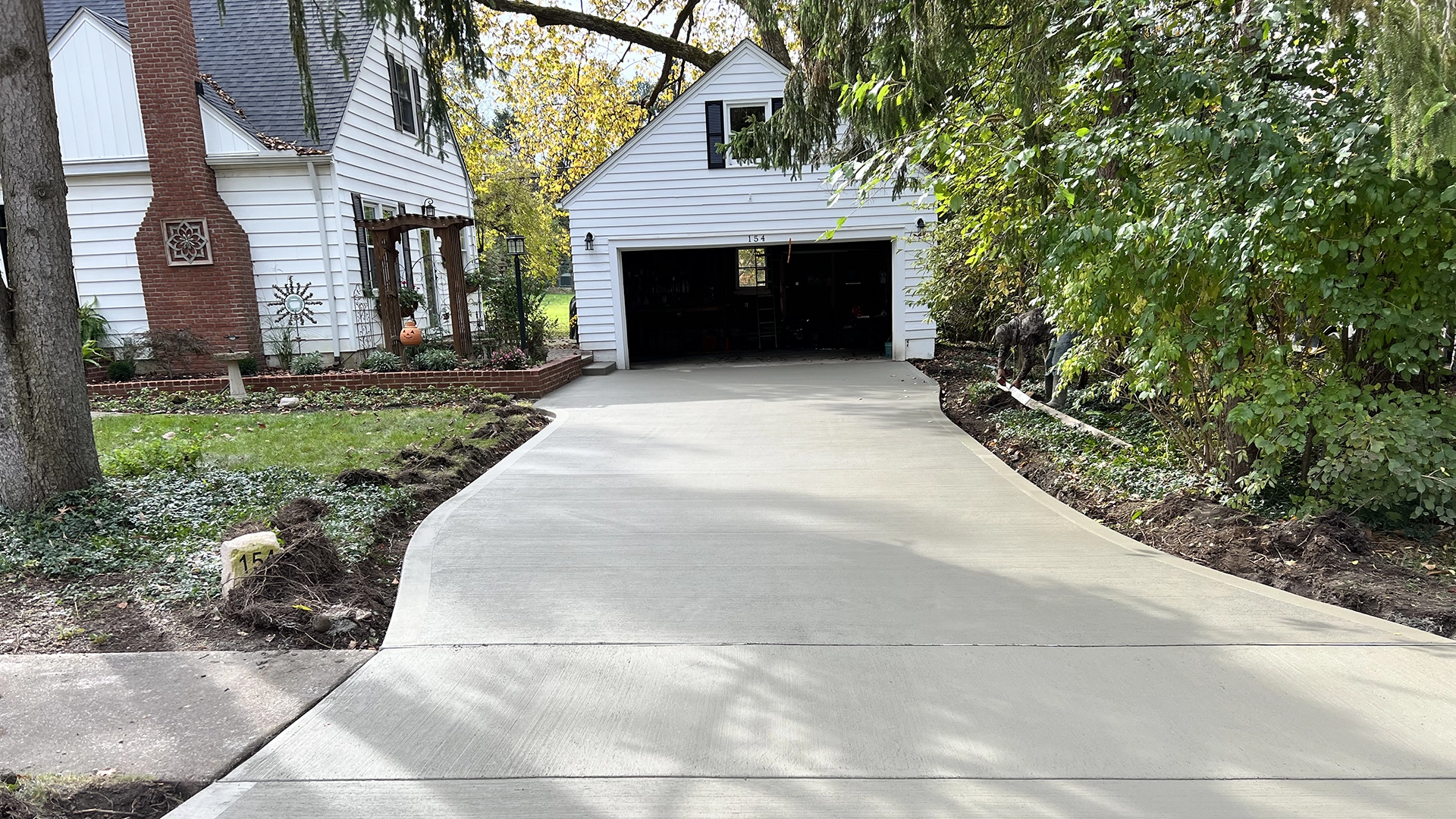 Concrete driveway leading up to open garage door