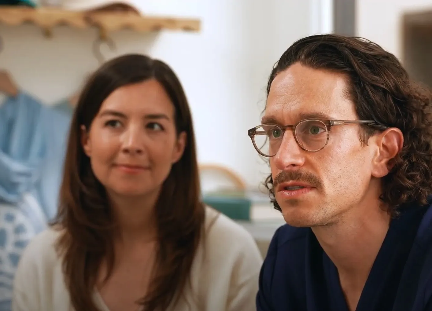 A man and a woman sitting next to each other.