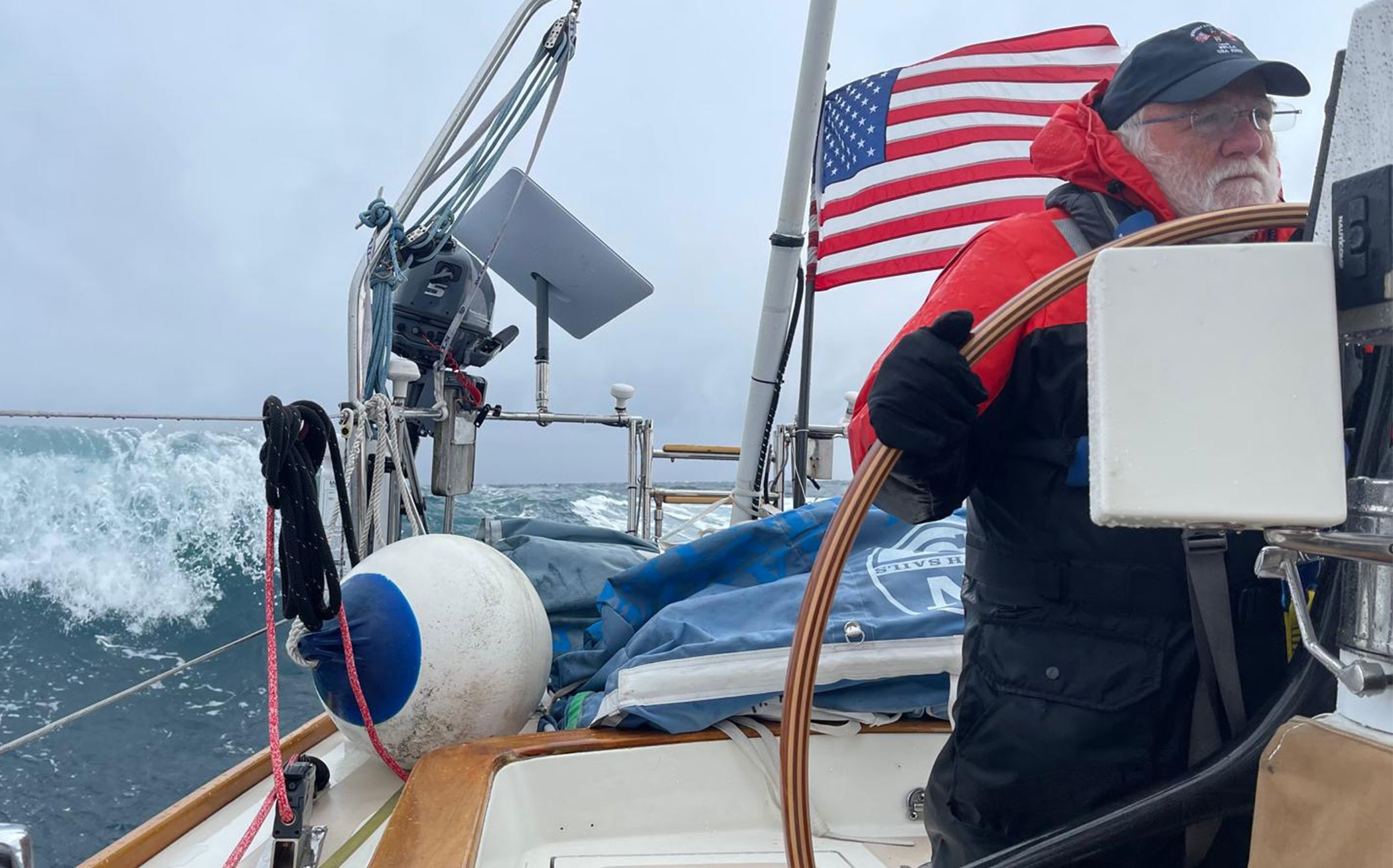 Paul Kanev at the helm sailing Momentum