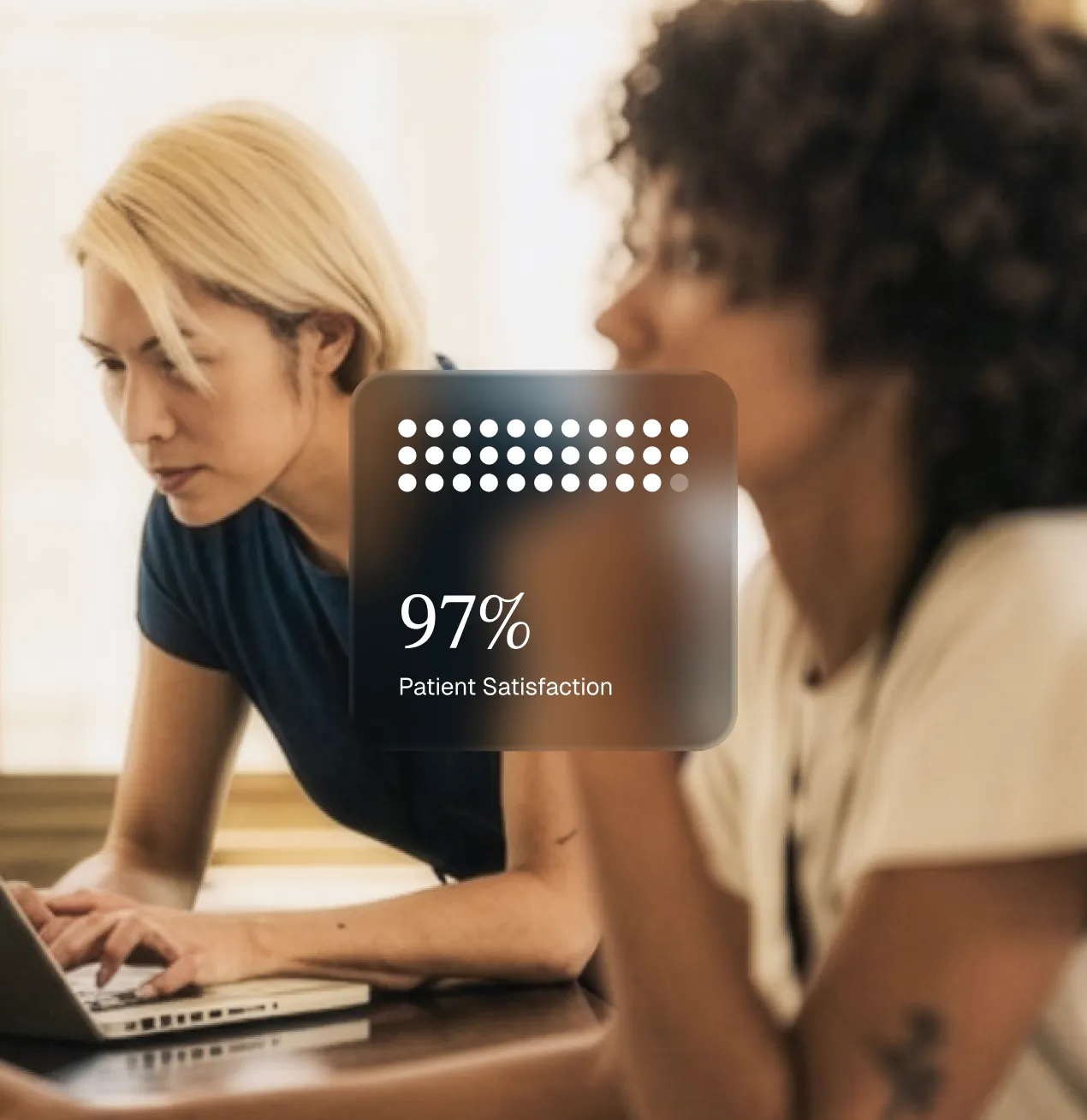 Two women working at a table, one focused on a laptop; an overlay shows 97% patient satisfaction.