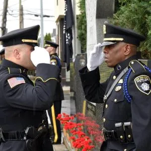 Two police officer saluting each other