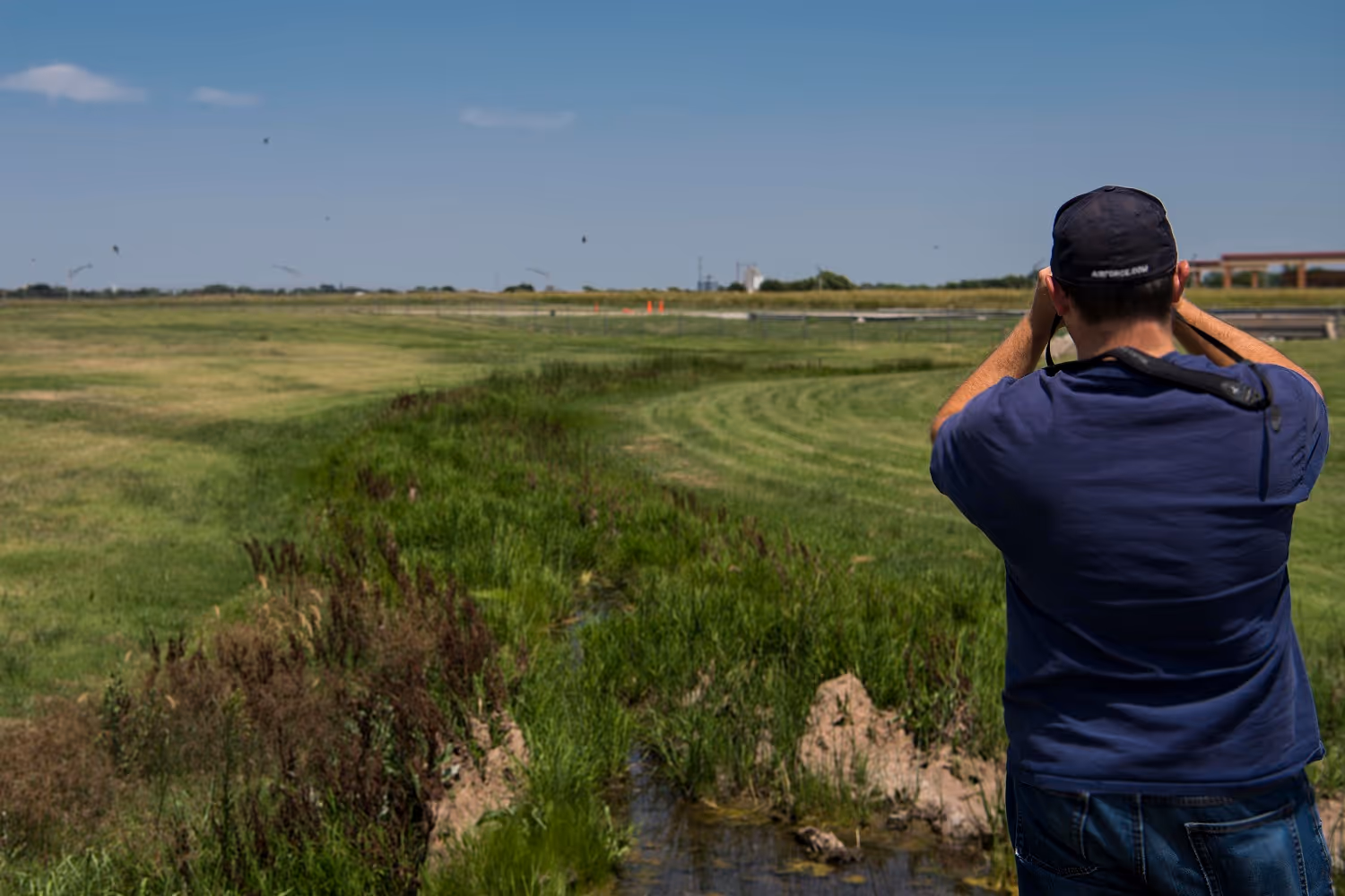 A wildlife biologist with the safety office at Vance Air Force Base monitors one of the drainages on the 2,000-acre military installation. (U.S. Air Force photo by Airman 1st Class Zachary Heal)