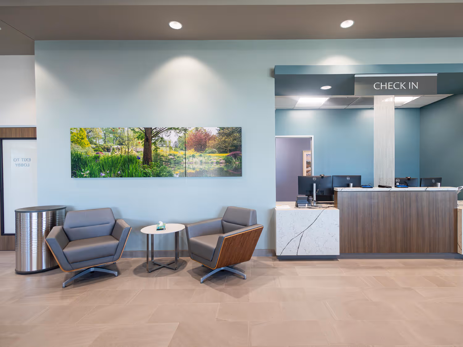 A check-in and waiting area in the medical clinic features clean, well-designed lighting.