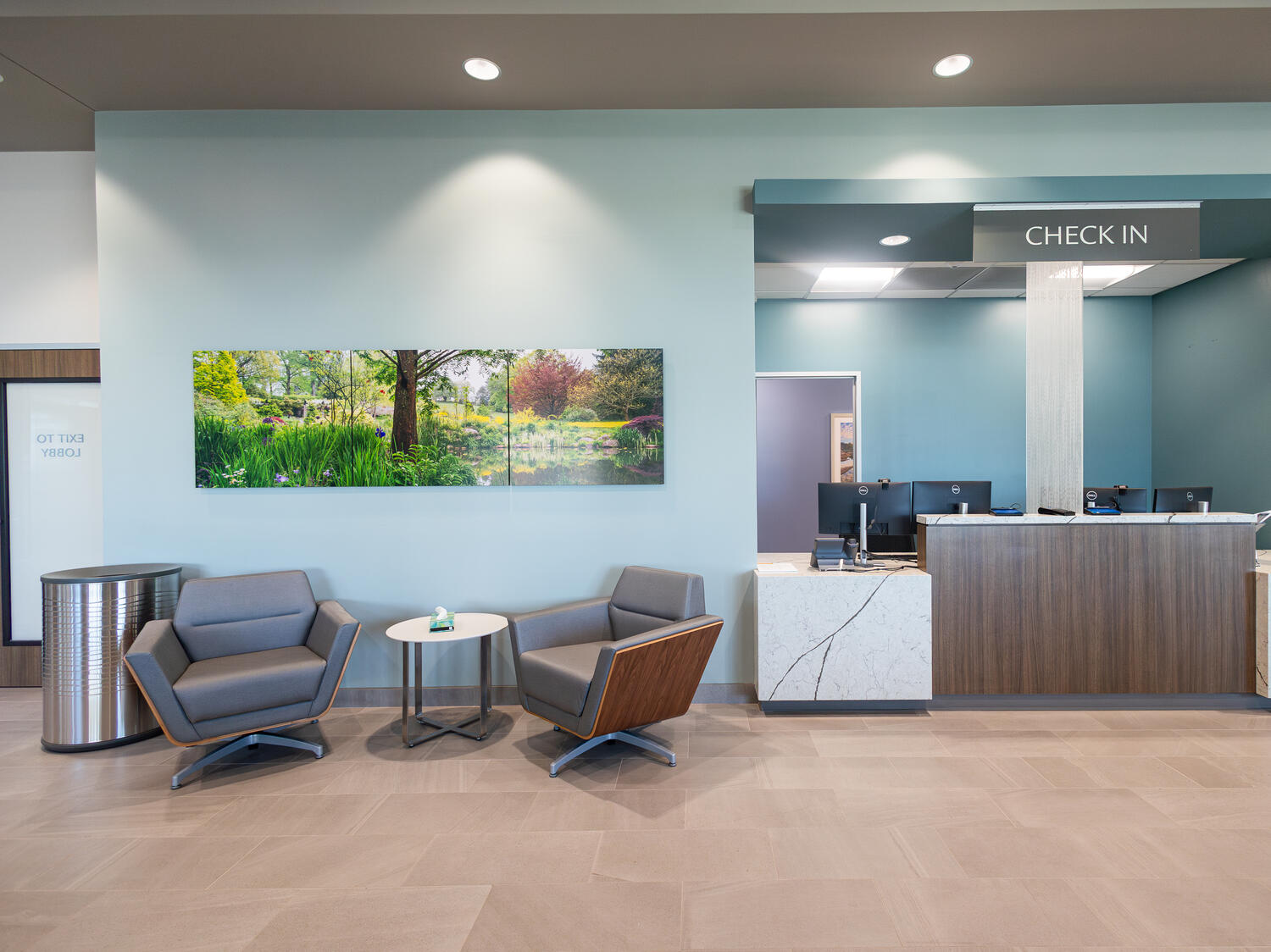 A check-in and waiting area in the medical clinic features clean, well-designed lighting..