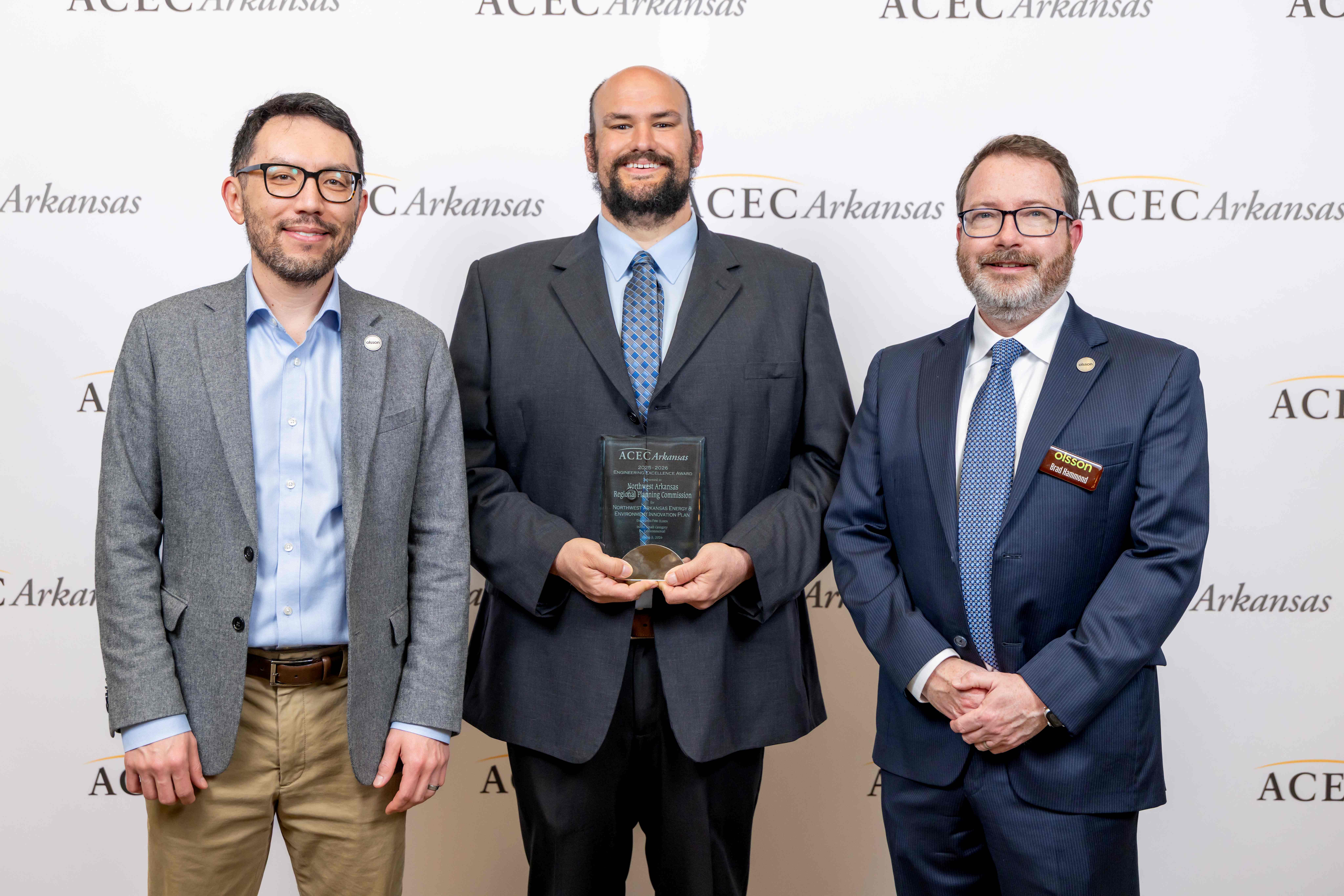 Olsson employees receiving an Engineering Excellence Award for their work on the Northwest Arkansas Energy and Environment Innovation Plan. The plan establishes a regional roadmap to achieve net zero emissions by 2050 across three counties.