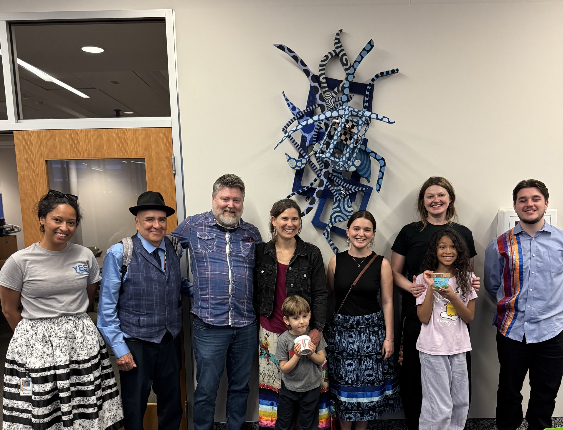 Attendees of the garden's ground blessing gathered afterward for a celebration. L to R: Kali Ratigan, Steve Tamayo, Dr. Travis Robbins, Dr. Regina Idoate, Gaizka Idoate, Arantza Irujo Urdiroz, Dr. Aislinn Rookwood, Zahra Rookwood, Xabier Irujo Urdiroz.  