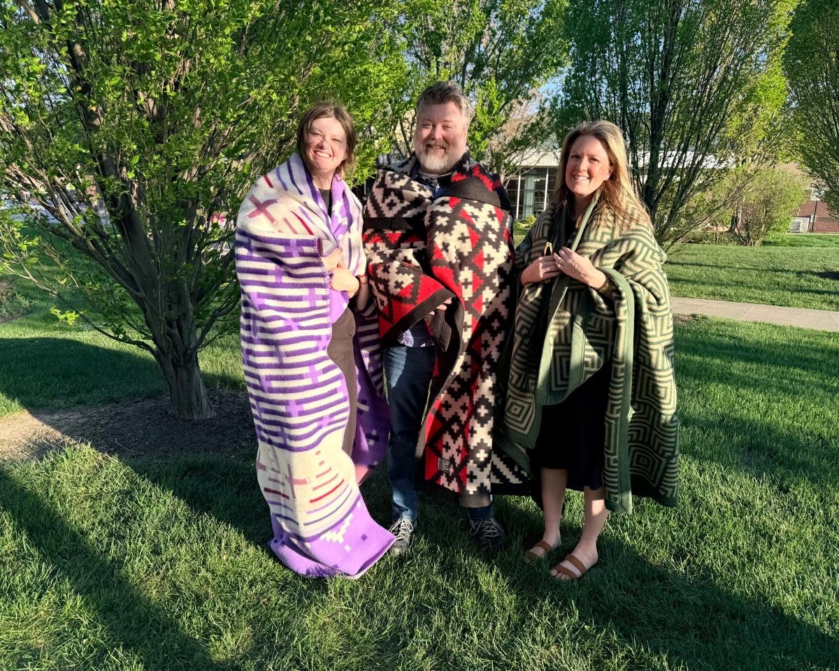Dr. Aislinn Rookwood, Dr. Travis Robbins, and Olsson senior landscape architect Kayla Meyer (L to R) were presented blankets in honor of their dedication to the garden and its mission.  