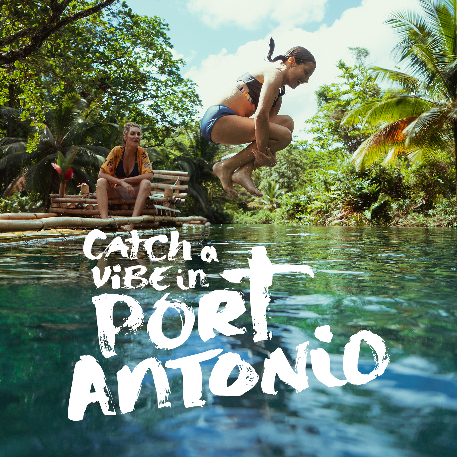 Young girl jumping into a clear blue river surrounded by lush greenery with a woman sitting on a bamboo raft nearby.